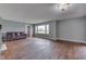 Bright living room featuring hardwood floors, modern light fixture and large window at 1601 Southern Ave, Beech Grove, IN 46107