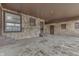 Spacious sunroom with stone walls, multiple windows, and convenient access to the outdoors at 1601 Southern Ave, Beech Grove, IN 46107