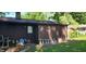 An exterior view of the back of the home with a with clutter in the yard and a partially obstructed view at 1619 Crest Ct, Indianapolis, IN 46214