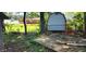 Backyard featuring a wooden deck, storage sheds, grassy areas, mature trees, and an enclosing fence at 1619 Crest Ct, Indianapolis, IN 46214