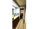 Bathroom with a double sink, wood cabinets, and a toilet visible through the doorway at 1619 Crest Ct, Indianapolis, IN 46214