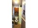 Modest bathroom with toilet and cabinet storage above, plus decorative wall art at 1619 Crest Ct, Indianapolis, IN 46214