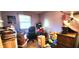 Cluttered bedroom with a window, boxes, and personal belongings at 1619 Crest Ct, Indianapolis, IN 46214