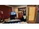 Simple bedroom featuring a bed, TV on a stand, and a closet filled with clothes at 1619 Crest Ct, Indianapolis, IN 46214
