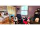 Modest bedroom with a window, closet, and filled with furniture and storage boxes at 1619 Crest Ct, Indianapolis, IN 46214