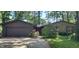 Home's exterior featuring a stone facade, brown garage door, well-maintained lawn, and mature landscaping at 1619 Crest Ct, Indianapolis, IN 46214