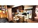 Charming kitchen with wood cabinets, brick accents, and a breakfast bar at 1619 Crest Ct, Indianapolis, IN 46214