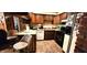 Functional kitchen with tiled floors, appliances, wood cabinets, and breakfast bar at 1619 Crest Ct, Indianapolis, IN 46214