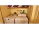Small laundry area equipped with a washer and dryer for added convenience at 1619 Crest Ct, Indianapolis, IN 46214