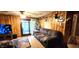 Comfortable living room with wood paneling, cozy seating, and sliding glass doors to outside at 1619 Crest Ct, Indianapolis, IN 46214