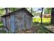 Rustic shed exterior, showcasing weathered wood and a glimpse of the surrounding green backyard at 1619 Crest Ct, Indianapolis, IN 46214