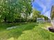 This spacious backyard features a shed, lush green grass, and plenty of shade from the mature trees at 167 Hilltop Farms Blvd, New Whiteland, IN 46184