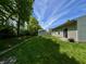 Well-maintained backyard featuring a storage shed, lush green grass, and mature trees at 167 Hilltop Farms Blvd, New Whiteland, IN 46184