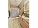 Well-lit bathroom with vanity, toilet, shower with striped curtain and decorative car related signs at 167 Hilltop Farms Blvd, New Whiteland, IN 46184