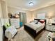 Bedroom featuring a dresser with TV, nightstands with lamps, and neutral colored walls at 167 Hilltop Farms Blvd, New Whiteland, IN 46184