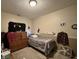 This bedroom has a single bed, a dresser, a white fan, and carpeted floors at 167 Hilltop Farms Blvd, New Whiteland, IN 46184