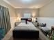 Bedroom with a dark bed frame, nightstands with lamps, and dresser with TV at 167 Hilltop Farms Blvd, New Whiteland, IN 46184