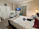 Bedroom with a dark bed frame, nightstands with lamps, dresser with TV, and closet at 167 Hilltop Farms Blvd, New Whiteland, IN 46184