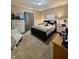 Bedroom with a dark bed frame, nightstands with lamps, and dresser with TV at 167 Hilltop Farms Blvd, New Whiteland, IN 46184