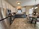 Well-lit kitchen with stainless steel appliances, two-tone cabinets, and a cozy eat-in area at 167 Hilltop Farms Blvd, New Whiteland, IN 46184