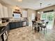 Charming eat-in kitchen with stainless steel appliances, two-tone cabinets, and backyard access at 167 Hilltop Farms Blvd, New Whiteland, IN 46184
