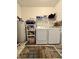 Functional laundry room equipped with washer, dryer, water heater, shelving, and decor at 167 Hilltop Farms Blvd, New Whiteland, IN 46184