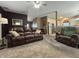 Inviting living room features a large leather sofa and chair, perfect for relaxation and entertaining at 167 Hilltop Farms Blvd, New Whiteland, IN 46184