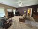 Comfortable living room featuring plush carpet, ceiling fan, and leather seating at 167 Hilltop Farms Blvd, New Whiteland, IN 46184