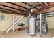 Utility area of basement featuring hot water heater, some storage, and exposed duct work at 1841 New St, Indianapolis, IN 46203