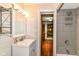 Bathroom features a single sink vanity, horizontal shiplap wall, and tiled shower/bath combo at 1841 New St, Indianapolis, IN 46203