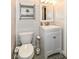 Bathroom features a toilet, sink, and shiplap wall at 1841 New St, Indianapolis, IN 46203