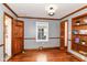 Bedroom features hardwood floors, wood trim, light grey walls, built-in shelves, and a window at 1841 New St, Indianapolis, IN 46203