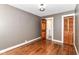 Bedroom features hardwood floors, grey walls, wood trim, and a closet at 1841 New St, Indianapolis, IN 46203