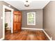 Bedroom features hardwood floors, dark grey walls, wood trim, and a window at 1841 New St, Indianapolis, IN 46203