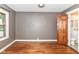 Bedroom features hardwood floors, grey walls, wood trim, and access to a bathroom at 1841 New St, Indianapolis, IN 46203
