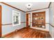 Bedroom features hardwood floors, light grey walls, wood trim, a window, and built-in shelves at 1841 New St, Indianapolis, IN 46203