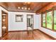 Dining area featuring wood-paneled ceiling, hardwood floors, and view to kitchen at 1841 New St, Indianapolis, IN 46203