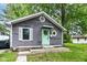 Charming home featuring gray siding, a welcoming mint-green front door, and fresh landscaping at 1841 New St, Indianapolis, IN 46203