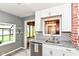 Kitchen with stainless appliances, grey walls, granite counter, and pass-through to dining at 1841 New St, Indianapolis, IN 46203