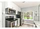 An updated kitchen featuring stainless steel appliances, granite counters, and a window view at 1841 New St, Indianapolis, IN 46203