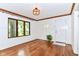 Living area with hardwood floors, white walls, and a round window adding charm at 1841 New St, Indianapolis, IN 46203