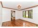 View of living room featuring wood floors, white walls, and access to the kitchen at 1841 New St, Indianapolis, IN 46203