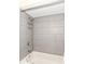 Shower and bath area with grey tile at 1841 New St, Indianapolis, IN 46203