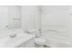 Clean white bathroom featuring a shower-tub combo and modern vanity with sink at 1936 Southernwood Ln, Indianapolis, IN 46231