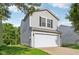 Charming two-story home featuring an attached garage and classic curb appeal at 1936 Southernwood Ln, Indianapolis, IN 46231