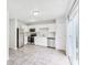 Well-lit kitchen with stainless steel appliances, white cabinets, and tile flooring at 1936 Southernwood Ln, Indianapolis, IN 46231