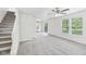 Bright living room with staircase, neutral paint, and outdoor access at 1936 Southernwood Ln, Indianapolis, IN 46231