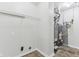 The utility room with water heater, washer-dryer hookups, and wire shelving at 1936 Southernwood Ln, Indianapolis, IN 46231
