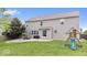 Large backyard with a patio, play set, and spacious grassy area at 19534 Forsythe Dr, Noblesville, IN 46060
