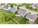 A well-maintained backyard featuring a patio, green lawn, mature trees, playground and trampoline at 19534 Forsythe Dr, Noblesville, IN 46060
